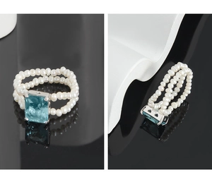 Macro detail of S925 silver stamp on double-layer pearl ring with blue square gemstone