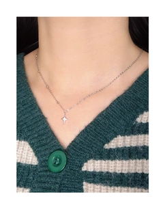 Close-up of S925 sterling silver asymmetrical star pendant necklace on model neck