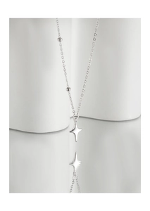 Detail of S925 silver necklace with starburst pendant and beaded chain on stone