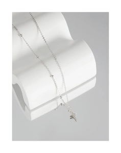 Macro view of minimalist S925 sterling silver necklace featuring a star pendant on satellite chain