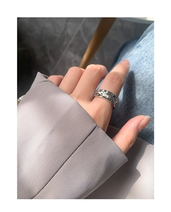 Detail showing irregular molten texture and silver finish of this wide open band ring