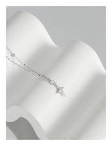 Macro detail of S925 sterling silver star pendant with intricate dot texture on a necklace