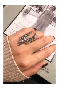 Macro shot of silver liquid metal texture ring with an organic lava shape on a finger