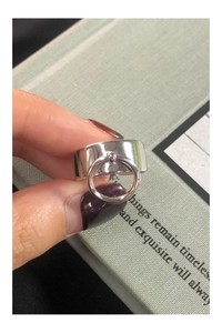 Detailed view of a wide S925 sterling silver ring featuring a small movable ring charm