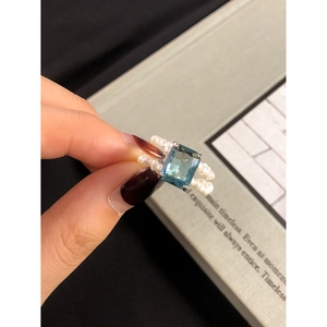 S925 sterling silver ring with blue zircon and natural pearl bands on a finger