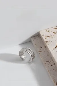 Detailed view of S925 sterling silver open ring with irregular lava textured surface