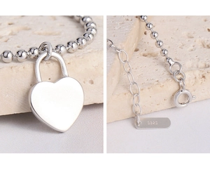 Detailed close-up of S925 sterling silver heart lock bead bracelet with lobster clasp
