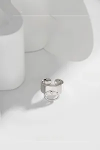 Detailed view of S925 sterling silver wide band ring featuring central ring charm and S925 stamp