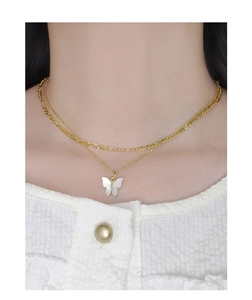 Détail du collier papillon doré à double couche avec incrustation de nacre sur modèle