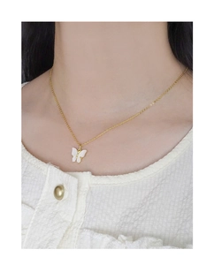 Gros plan d'un collier papillon en argent sterling S925 porté au cou d'une femme