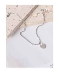 Macro shot of S925 sterling silver heart lock charm with bead chain and hallmark