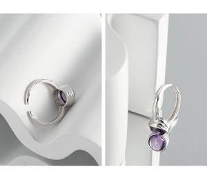 Detailed close-up of a S925 silver ring featuring an irregular texture and purple zircon