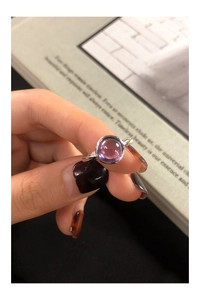 Close-up of S925 silver ring featuring a round purple zircon in a bezel setting