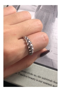 Detail of twisted croissant ring in S925 sterling silver on woman finger
