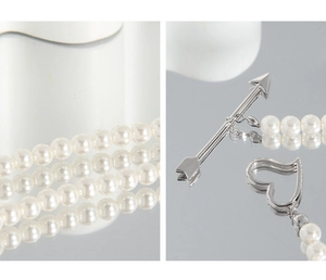 Detail of cupid arrow toggle and heart ring clasp on multilayer pearl necklace