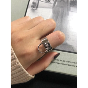 Minimalist wide band S925 sterling silver ring with small circular link charm on finger