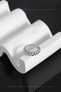 Macro detail of silver S925 sterling silver croissant ring with twisted texture