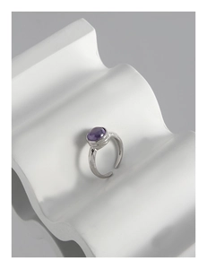 Macro detail of silver S925 ring with irregular hammer texture and purple zircon stone
