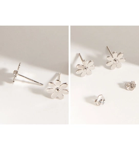Macro detail of S925 sterling silver daisy earrings featuring butterfly backs and high polish