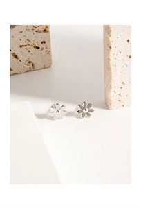 Macro shot of polished silver daisy flower stud earrings on minimalist stone display