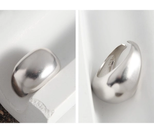 Macro shot of minimalist S925 sterling silver ring showing its sleek adjustable opening