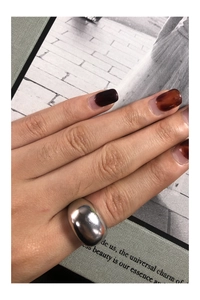 Close-up of a wide polished S925 sterling silver dome ring worn on a finger