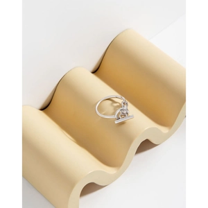 S925 sterling silver chain ring with a toggle clasp on a beige textured display stand