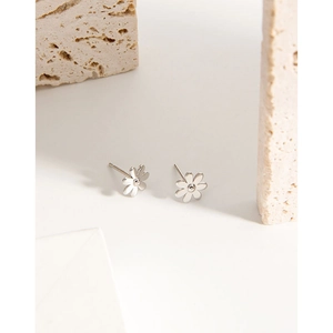 Elegant S925 sterling silver daisy stud earrings on minimalist stone display stand