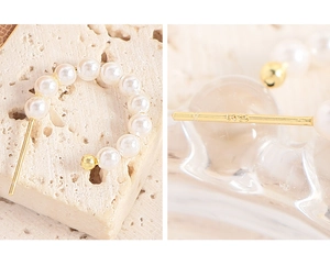 Macro shot of S925 sterling silver hallmark on elegant mini pearl hoop earrings