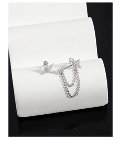 Macro detail of S925 sterling silver star earrings with zircons and double layer chains