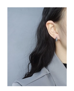 Minimalist silver geometric stud earring shown on model in a modern style