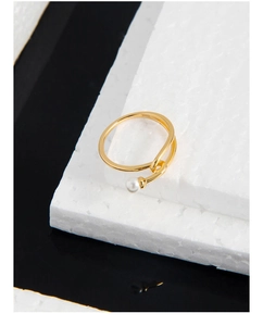 Detailed close-up of S925 hallmark on a minimalist gold ring with a single white pearl
