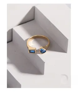 Macro detail of geometric open ring with blue rectangle and triangle zircons