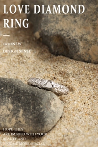 Macro detail of silver S925 heart ring with textured finish on natural rock surface