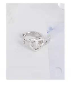 Detail view of S925 silver belt buckle heart ear cuff with polished metallic finish
