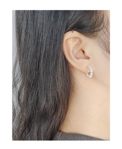 Close-up of elegant C-shaped S925 silver hoop earrings with mini white pearls