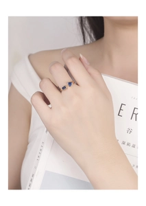 Detail of adjustable gold ring with deep blue geometric cubic zirconia stones