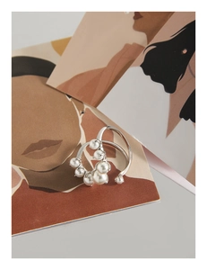 Close-up of S925 silver U-shape ring featuring multi-size white pearls on artistic card
