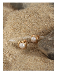 Detailed close-up of S925 silver pearl flower earrings on a natural stone background