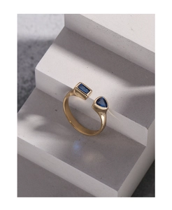 Detail of S925 silver open ring with blue rectangle and triangle zircon crystals