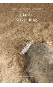 Detailed macro shot of textured silver heart ring resting on natural stone