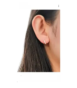 Close-up of elegant rose gold S925 silver hoop earrings with white zircon on ear
