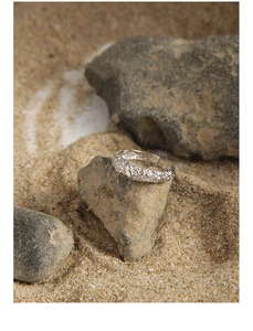 Detailed shot of S925 silver ring featuring irregular crushed texture and smooth heart motif