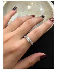 Macro detail of S925 silver heart ring featuring unique crushed silver hammer texture
