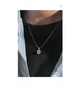 Macro shot of silver S925 necklace featuring an oval moonstone pendant with ice crack texture