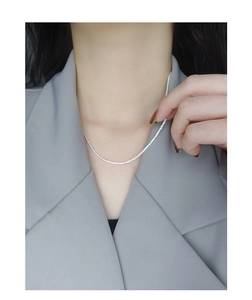 Close-up of S925 sterling silver tennis chain necklace with sparkling zircon stones