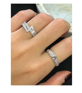 Detail shot of a S925 silver ring featuring a textured band with a polished heart charm