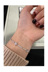 Close-up of a minimalist S925 silver star bracelet with zircon inlay worn on wrist