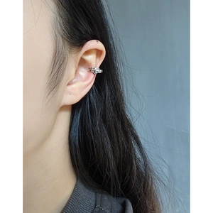 Minimalist S925 sterling silver heart-shaped ear cuff for women on a model ear