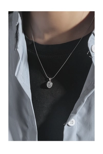 Detailed view of an oval moonstone pendant on a fine S925 sterling silver chain